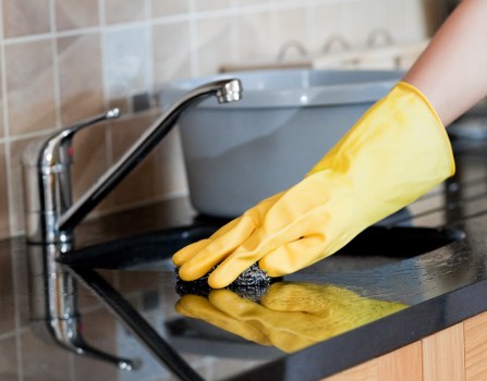 Cleaner working in a modern Hackney office meeting room